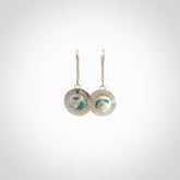 These are a pair of beautiful Aotea Stone and sterling silver earrings. It is carved from Aotea Stone from New Zealand. It is a light blue and white colour with sterling silver. Hand made here in New Zealand by Ana Krakosky.